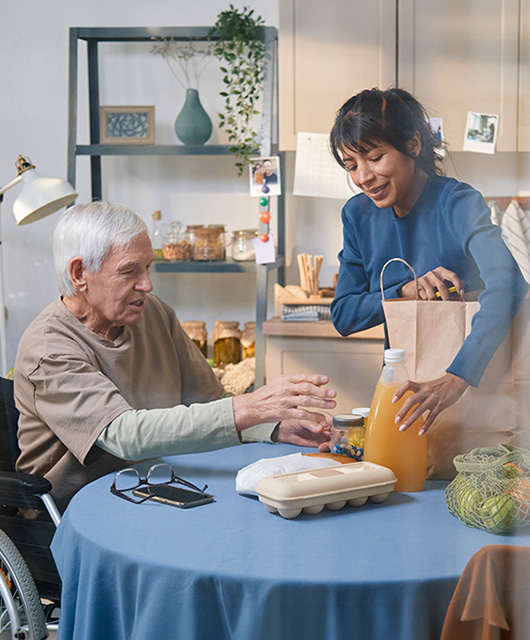 Helping Aged Man in the Kitchen
